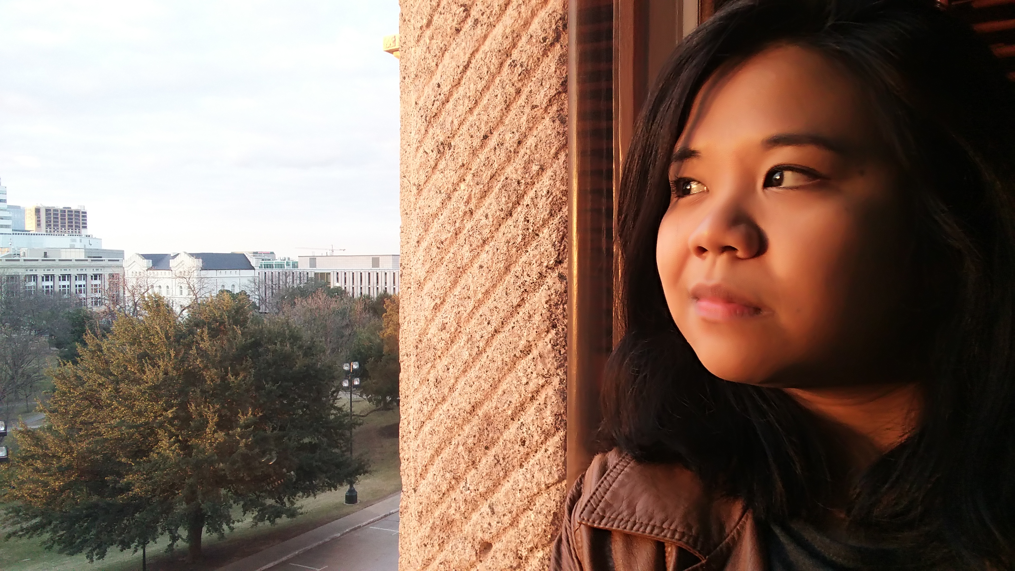 Side profile of woman staring out of building